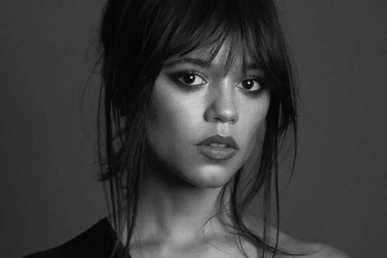 Jenna Ortega, aktorka znana z roli Wednesday Addams, w czarno-białym portrecie z intensywnym spojrzeniem.
